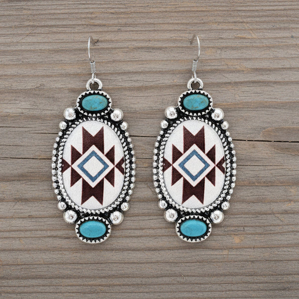 Pair of earrings with geometric pattern and turquoise stones on a white background
